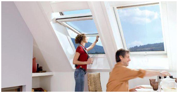 Fenêtre de toit ouverte dans une pièce mansardée